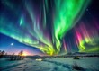 © Naowarat - Aurora borealis display in dark winter sky