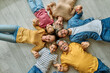 © Lumos sp - Portrait of a three generation family, grandparents, parents and children sitting on floor  and having fun posing at home