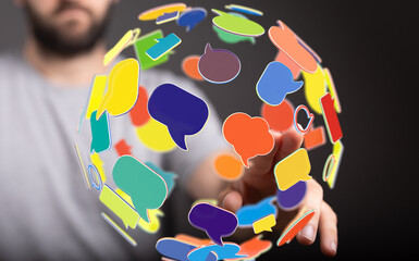 Person interacting with a digital sphere of colorful speech bubbles, representing global communication and social media.