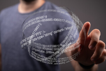 person touching a futuristic digital interface with lines of code.