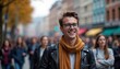 © AiGalaxy - A young Caucasian man with glasses and brown hair smiles in a busy street filled with diverse people. Autumn leaves are visible in the background.