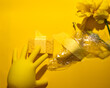 © fotoworld - Yellow surreal tableau, rubber glove mimics petal dance, eco-cleaning meets Dadaist dream, bright spark for Imbolc renewal