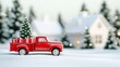 © Iaroslav - Red toy pickup truck carrying christmas tree and gifts is driving on snowy road to house in blurred background