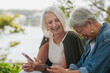 © Austockphoto - Seniors sharing stories about photos on their phone