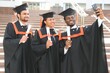 © Serhii - Diverse international students with diplomas attending graduation ceremony, happy multiracial group of students