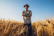 © djoronimo - Senior farmer is standing in his growing wheat field. He is satisfied with growth of crops.