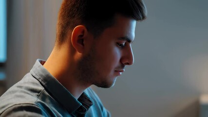Professional programmer coding intensely on laptop, sitting in modern workspace with deep concentration and technological precision