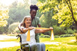 © zinkevych - Elderly woman in wheelchair with caregiver during park rehab