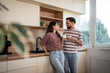 © Migma_Agency - Happy couple enjoying milk in modern kitchen