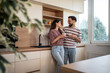 © Migma_Agency - Happy couple enjoying milk in modern kitchen