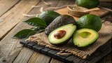 Fresh Ripe Avocados With Leaves on Wooden Board and Burlap