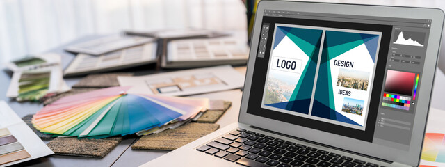Interior designer workspace table and architecture software on laptop screen with mood board materials and colorful swatch color for color selection. Modern interior design office. Insight