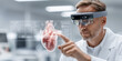 © Artificial South - A focused doctor wearing AR glasses examines a heart hologram in a modern lab, merging medicine with advanced tech