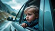 © Lasvu - A small alpine kid looks out of the car window