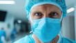 © svastix - A close-up shot of a medical professional in scrubs and mask, showcasing determination and focus typical of healthcare workers in a hospital environment during critical times.