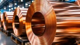 A shiny roll of copper wire in a manufacturing facility reflects the ambient light, showcasing its metallic texture and vivid color, emphasizing its industrial significance.
