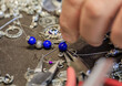 © SvetlanaSF - Jeweler s workspace with lapis lazuli and silver beads, tools, for a custom made unique bracelet at the Grand Bazaar in Istanbul, Turkey