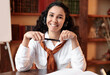 © Prostock-studio - Front portrait of confident smiling curly young woman wearing headset sitting at desk at home office, library with bookshelves in the blurred background. Female student holding pen, posing at camera