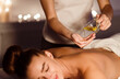 © Prostock-studio - Relaxing treatment. Masseur pouring aroma oil on hand, preparing for massage
