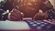 © soem - A soldier in uniform writing on a piece of paper with an American flag in the background.
