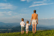© Westend61 - Mother with children enjoying a scenic view in nature