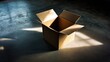 © Juan - Cardboard box opened on concrete floor under dramatic lighting for shipping packing storage visuals