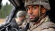 © Larysa - Male service member with a beard and helmet, dressed in military camouflage, sitting in an armored vehicle, looking directly at the camera, with another military person in the background