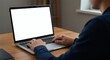 © SentiStock - Close-up of hands using laptop with empty screen for UI testing or software interface mockup in home office