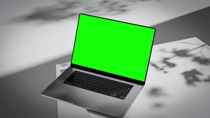 Wall Mural - elegant laptop with green screen on geometric pedestal. camera smoothly tilts down toward the screen