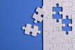 © Mulad Images - White puzzle with missing piece on blue background. Flat lay. Top view
