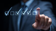 © Enrique - Businessman touching to tick correct mark in checklist with progressive loading status to remind work task progressive for project develop management and tracking concept