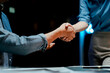 © Daenin - Portrait of cooperation between businessman and woman in office at night. Teamwork handshake.