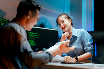 team of programmers working late at night at a software development company, web developers, and cod