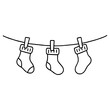 © liza - Three cozy socks hanging on a clothesline — simple and cute line art illustration with warm, homey vibes