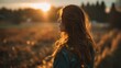 © standret - Woman gazing into sunset in a serene natural outdoor setting