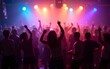 © fu - Crowd dancing under colorful lights at a lively party or concert. High quality