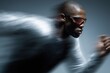 © Maria - Sprinter races with blurred motion, sunglasses perfectly sharp in dramatic contrast