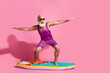 © deagreez - Photo of cheerful crazy cool grandfather wear swimsuit resort surfing wave isolated on pink color background
