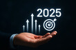 © MdAbulBasar - Businessman holding glowing arrows and target symbolizing future goals and success in 2025