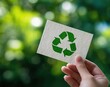 © Rahul - Hand holding recycled paper with green recycle symbol