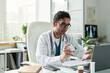 © pressmaster - Middle aged Caucasian male doctor consulting patient with diabetes via video call, holding medication bottle and explaining prescription instructions in modern medical office setting