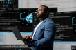 © DC Studio - African american coder expert immersing in software development for a high tech work environment, focused on laptop screen. Engineer enjoying coding life and IT cloud computing.