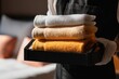 © Underhood - A beautiful young chambermaid, wearing her uniform, arrives at the hotel room with clean towels and other supplies in hand
