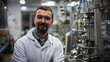 © xuxu - A male scientist in a lab coat looks at the camera with his arms crossed in images of a modern science laboratory.