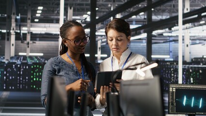 data center teamworking colleagues performing maintenance on server racks used for artificial intell