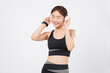 © sorapop - Dance to the beat with a fit Asian woman in sportswear enjoying music. Later, she breaks into a joyful dance, embracing fitness, lifestyle, and pure energy. isolated studio white background