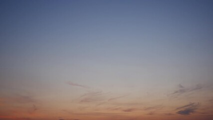 Wall Mural - A warm sunrise sky timelapse with soft golden light spreading gently across wispy clouds, creating a peaceful and hopeful atmosphere as the sun rises over a calm horizon, signaling a fresh new day.
