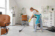 © Pixel-Shot - Female janitor vacuum cleaning floor in office
