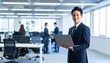 © 순단 강 - A Korean man in a suit holding a laptop computer to the right, with luxury office furniture in the blurred background