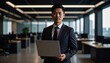 © 순단 강 - A Korean man in a suit holding a laptop computer to the right, with luxury office furniture in the blurred background